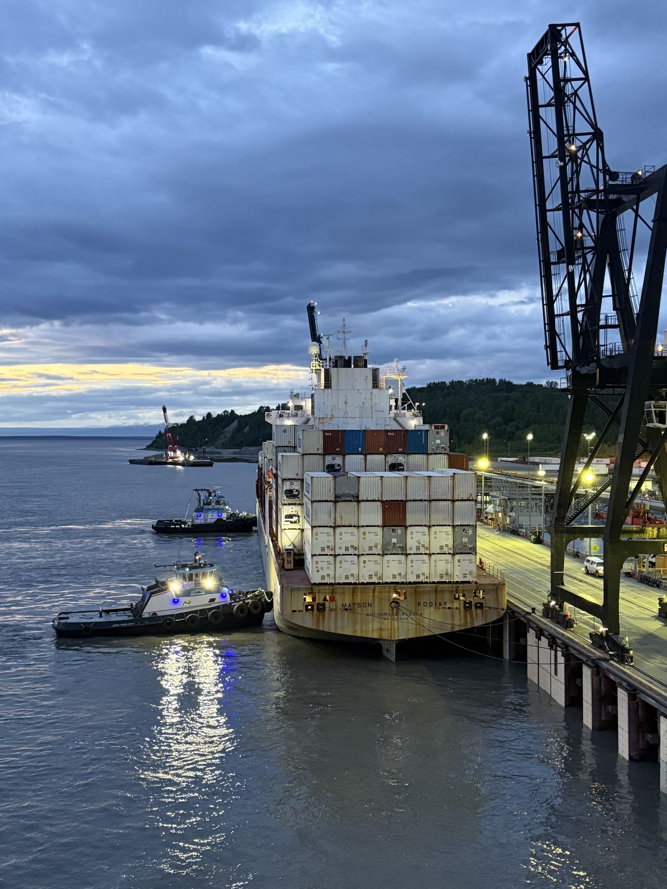 A container ship at the Port of Alaska in Anchorage with tugs alongside