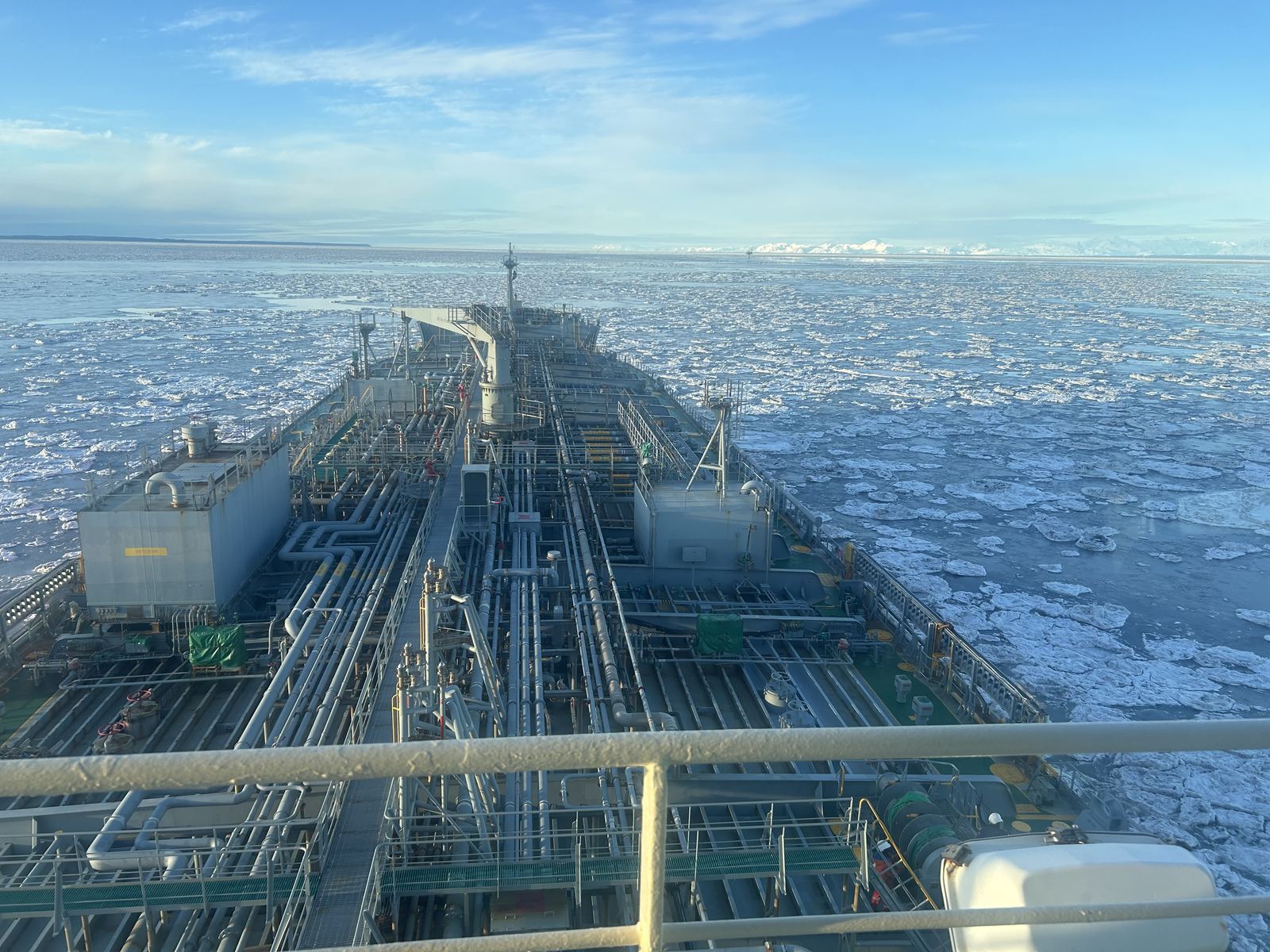 Looking forward over a tanker's deck through pack ice