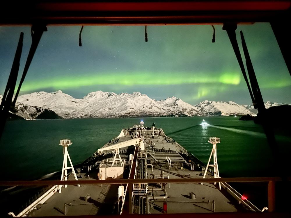 Northern lights over Valdez Arm through a tanker's bridge windows