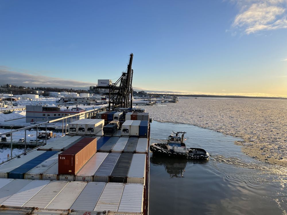 A container ship and tug in the ice at the Port of Alaska