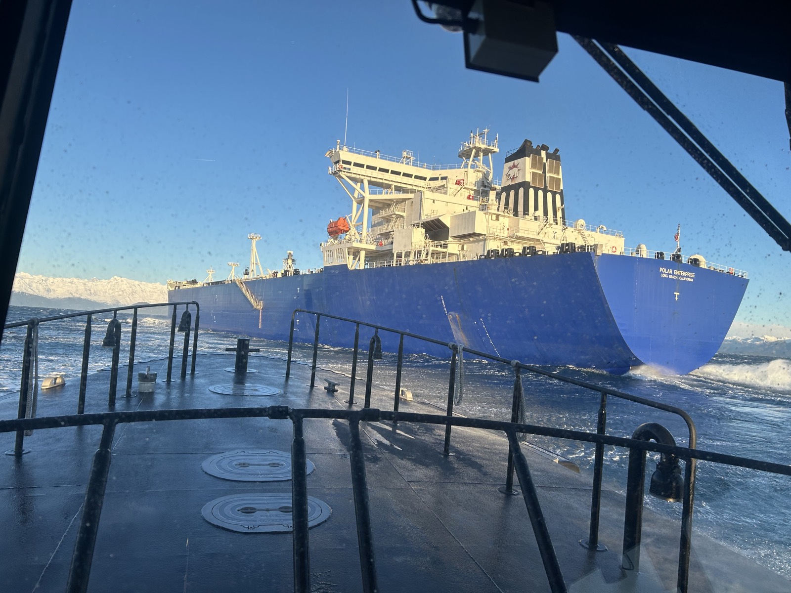 A ship seen through the window of a SWAPA pilot boat underway